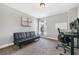 Bedroom with carpeted floors with a window, a desk, and a black futon sofa at 1925 Piedmont Cove Ln, Cumming, GA 30040