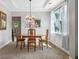 Formal dining room featuring a modern chandelier, tray ceiling and a view to the backyard at 1925 Piedmont Cove Ln, Cumming, GA 30040