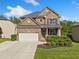 Beautiful brick two-story home with a well-manicured lawn, flower bed and a two car garage at 1925 Piedmont Cove Ln, Cumming, GA 30040