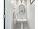 Neat half bathroom with a pedestal sink, oval mirror, new fixtures and fresh paint at 1925 Piedmont Cove Ln, Cumming, GA 30040