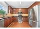 Modern kitchen features stainless steel appliances, wood cabinets, granite countertops and a window view at 1925 Piedmont Cove Ln, Cumming, GA 30040