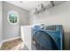 Bright laundry room features modern washer and dryer, plus ample shelving for storage solutions at 1925 Piedmont Cove Ln, Cumming, GA 30040