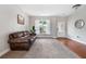 Light and airy living room features neutral paint, carpet, hardwood floors and a great view of the outdoors at 1925 Piedmont Cove Ln, Cumming, GA 30040