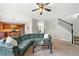 Open concept living room with a staircase, sofa and a view to the kitchen at 1925 Piedmont Cove Ln, Cumming, GA 30040