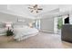 Bright primary bedroom with large windows, recessed lighting, and a tray ceiling with fan at 1925 Piedmont Cove Ln, Cumming, GA 30040
