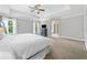 Bright primary bedroom with large windows, recessed lighting, and a tray ceiling with fan at 1925 Piedmont Cove Ln, Cumming, GA 30040