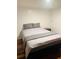 Comfortable bedroom featuring a bed with grey bedding and wood flooring at 2021 Moody Drive Southwest, Atlanta, GA 30315
