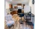 Bright kitchen featuring wood cabinets, a black countertop, and a comfortable rocking chair at 2021 Moody Drive Southwest, Atlanta, GA 30315