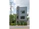 Modern townhome with brick and metal siding, large windows, and manicured landscaping at 417 E College Ave # 102, Decatur, GA 30030