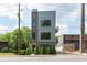 Contemporary three-story home featuring mixed brick and metal siding with black framed windows at 417 E College Ave # 102, Decatur, GA 30030