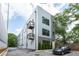 Modern townhome exterior with gray siding, brick accents, balconies, and ample parking at 417 E College Ave # 102, Decatur, GA 30030