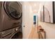 Hallway with a full size washer and dryer along with art, a bench, and view into a bedroom at 417 E College Ave # 102, Decatur, GA 30030