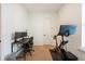 Bright home office with a desk setup and workout bike for a convenient and healthy lifestyle at 417 E College Ave # 102, Decatur, GA 30030