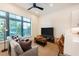 Inviting living room featuring a comfortable sofa, large window, and modern ceiling fan at 417 E College Ave # 102, Decatur, GA 30030