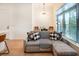 Bright, airy living space featuring a modern sofa, hardwood floors, and contemporary lighting at 417 E College Ave # 102, Decatur, GA 30030