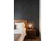 A closer view of the bedroom's accent wall and bedside table at 417 E College Ave # 102, Decatur, GA 30030