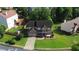 Aerial view of brick home, showcasing the landscaped yard and driveway at 5281 Tormeall Trce, Suwanee, GA 30024