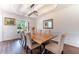 Formal dining room with wood table, upholstered chairs, and decorative mirror at 5281 Tormeall Trce, Suwanee, GA 30024
