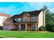 Lovely two-story home with brick facade, manicured lawn and shrubbery at 5281 Tormeall Trce, Suwanee, GA 30024