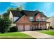 Beautiful brick home with lush green lawn and a spacious driveway at 5281 Tormeall Trce, Suwanee, GA 30024