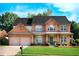 Charming brick home featuring a well-manicured lawn and a two-car garage at 5281 Tormeall Trce, Suwanee, GA 30024