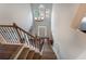 Grand foyer with hardwood floors, a chandelier, a high arched window, and wrought iron staircase at 5281 Tormeall Trce, Suwanee, GA 30024