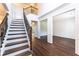Bright foyer with wooden staircase and hardwood flooring at 5281 Tormeall Trce, Suwanee, GA 30024