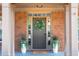 Elegant front entrance with decorative wreath and potted plants at 5281 Tormeall Trce, Suwanee, GA 30024