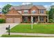 Charming two-story brick home with a well-manicured lawn and a two-car garage at 5281 Tormeall Trce, Suwanee, GA 30024