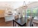 Open concept floor plan featuring a kitchen with quartz countertops and a dining area at 5281 Tormeall Trce, Suwanee, GA 30024