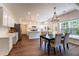 Bright, eat-in kitchen with white cabinetry, island, and stainless appliances at 5281 Tormeall Trce, Suwanee, GA 30024