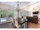 Open concept living room with hardwood floors, fireplace, a large windows and a comfortable seating area at 5281 Tormeall Trce, Suwanee, GA 30024