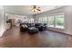 Open concept living room with a view of the kitchen and large windows overlooking the yard at 5281 Tormeall Trce, Suwanee, GA 30024