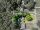 Overhead view of a property surrounded by lush greenery, with nearby homes at 664 Mcburnette Ne Rd, Marietta, GA 30068