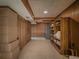 Finished basement featuring tile floors, wood paneling, storage shelves, and curtains at 664 Mcburnette Ne Rd, Marietta, GA 30068