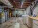 Utility area in the unfinished basement with washer, dryer, and exposed plumbing at 664 Mcburnette Ne Rd, Marietta, GA 30068