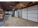 Unfinished basement with concrete floor, exposed ceiling and a garage door at 664 Mcburnette Ne Rd, Marietta, GA 30068