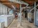 Utility area in the unfinished basement with washer, dryer, and exposed ceiling at 664 Mcburnette Ne Rd, Marietta, GA 30068