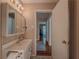 Bathroom featuring vanity with sink and view to hardwood hallway at 664 Mcburnette Ne Rd, Marietta, GA 30068