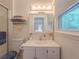 Well-lit bathroom with a sink, toilet, and a view of the exterior from the window at 664 Mcburnette Ne Rd, Marietta, GA 30068