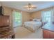 Comfortable bedroom with large windows and a ceiling fan, creating a bright and airy space at 664 Mcburnette Ne Rd, Marietta, GA 30068