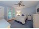 Comfortable bedroom with blue walls, a ceiling fan, and french doors leading to the outdoor space at 664 Mcburnette Ne Rd, Marietta, GA 30068