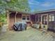A wooden deck area features a grill, covered porch, and access to the main house in a relaxed outdoor setting at 664 Mcburnette Ne Rd, Marietta, GA 30068