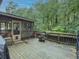 Wooden deck with a screened in porch and views of the treed backyard at 664 Mcburnette Ne Rd, Marietta, GA 30068