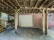 An exterior of the house showcases a covered parking area with a garage door, supported by wooden beams at 664 Mcburnette Ne Rd, Marietta, GA 30068