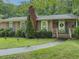 Charming brick home with well-maintained landscaping and a cozy front porch at 664 Mcburnette Ne Rd, Marietta, GA 30068