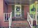 Covered front porch with brick steps and decorative wreath on the door at 664 Mcburnette Ne Rd, Marietta, GA 30068