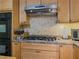 Close up on the kitchen with a gas cooktop and tile backsplash at 664 Mcburnette Ne Rd, Marietta, GA 30068