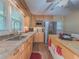 Modern kitchen with stainless steel appliances, natural wood cabinets, laminate countertops, and a view of the backyard at 664 Mcburnette Ne Rd, Marietta, GA 30068