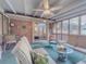 Relaxing sunroom with a ceiling fan, comfortable seating, and an open view into the bedroom, bathed in natural light at 664 Mcburnette Ne Rd, Marietta, GA 30068